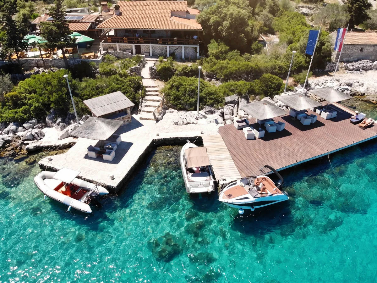 Trabakul Kornati – aerial drone view of the restaurant with dock, speedboats and crystal-clear Adriatic